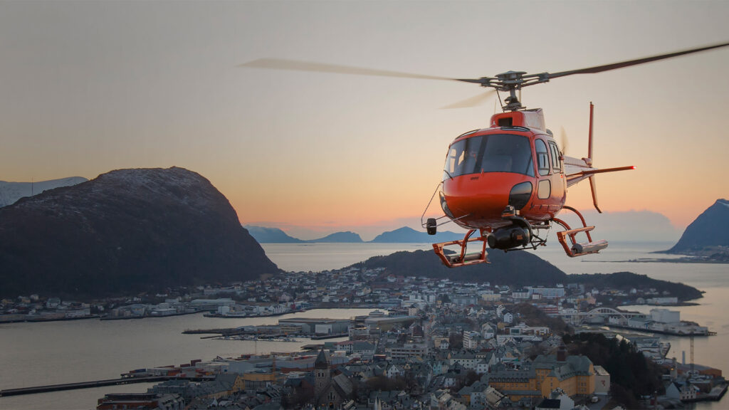 Helicopter over Ålesund city by night